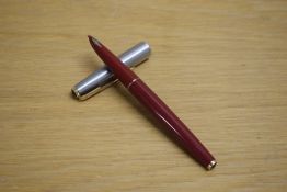 A Parker 61 capillary fill fountain pen in rage red with lustraloy cap with gold trim