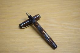 A Burnham unmarked lever fill fountain pen of small proportions in grey gold and brown swirl with