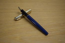 A Parker 75 Insignia converter fill fountain pen in in blue with custom gold plated cap having