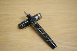 A Parker Duofold Standard button fill fountain pen in green and black marble with broad gold cap