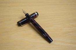 A Parker Duofold Deluxe Junior button fill fountain pen in rose and black with two narrow and one