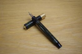 A Parker Duofold Lady Lucky Curve button fill fountain pen in jade green with a broad gold band to