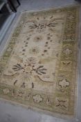 A traditional fireside rug, having cream ground, approx. 170 x 122cm
