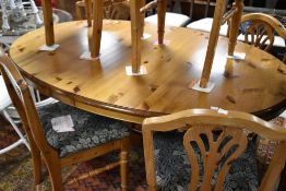 A Ducal pine oval extending dining table and set of six similar chairs