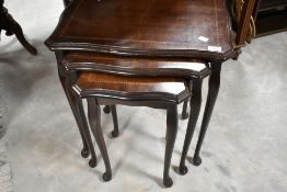 A period style nest of three occasional tables having inlaid decoration