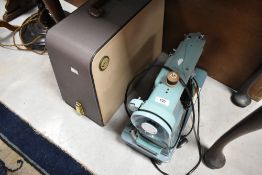 A vintage Singer electric sewing machine and case , probably mid 20th Century