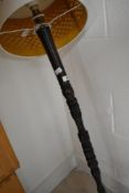 A traditional turned standard lamp, possibly fashioned from a newel post