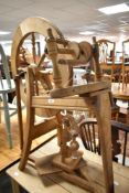 A traditional light framed spinning wheel