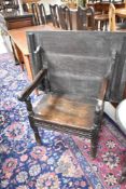 A period oak monks chair of simplistic form, width approx. 87cm