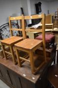 A pair of vintage childs school chairs