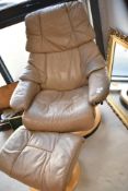 A Stressless swivel recliner chair in beige leather and a similar footstool, quite a bit of wear but