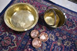 A selection of Antique brass and copper wares including graduated brass jam pans and a set of