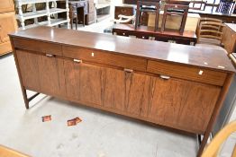 A vintage rosewood Nathan sideboard having triple drawer and cupboard with stylised handles, width