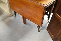 A Victorian mahogany drop leaf dining table having turned legs, approx width 108cm