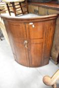 A 19th Century oak bow fronted corner cupboard, height approx. 96cm