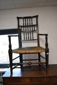 A traditional harlequin set of six (five plus one) spindle back chairs , having rush/seagrass seats