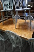 A traditional pine and painted kitchen farmhouse table and eight painted wheelback dining chairs,