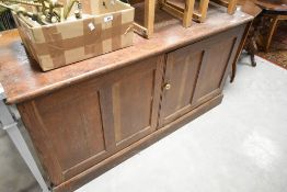 A late 19th or early 20th Century cupboard base having panelled doors