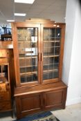 An early to mid 20th Century (in the Art Deco style) mahogany bookcase having double cupboard under,