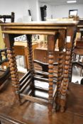 A late 19th or early 20th Century oak nest of three tables, having bobbin turned supports, lovely