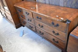 A rustic oak (heavily stained) sideboard /dresser base of shallow proportions, with six drawers,