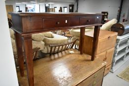 A modern hardwood side table, having two frieze drawers, width approx. 120cm