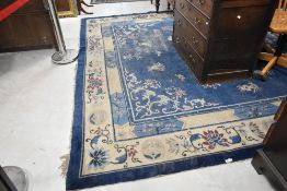 A 20th century traditional room sized carpet square having blue ground with foliate pattern, approx.