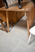 A vintage Ercol Windsor style drop leaf table, approx width 74cm (open length 137cm)