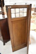 A late 19th or early 20th Century tri-fold modesty screen or room divider, having leaded glazed