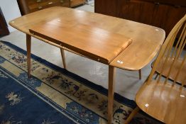 A light Ercol Windsor style extending dining table, approx. 152 x 82cm, plus butterfly leaf adding