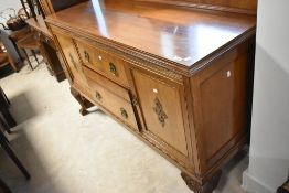 An early 20th Century mahogany sideboard having ledge back with two central drawers flanked by