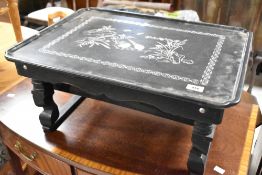 A laquerwork occasional table having mother of pearl chinoiserie bird and foliate decoration,