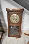 An early 20th Century oak cased wall clock having silver dial with arabic numerals