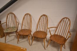 A set of four (two plus two) light Ercol high hoop and stick back dining chairs