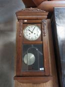 An early 20th Century oak cased wall clock,