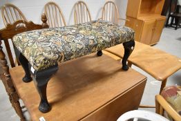 An early 20th Century footstol having Queen Anne revival legs