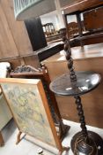 An early 20th Century standard lamp table with twist frame, and two fire screens