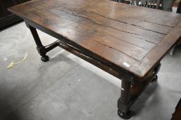 A period style rustic oak farmhouse kitchen table in the 18th Century style having plank style top ,