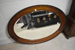 An early 20th Century mahogany oval mirror, diameter approx 88cm