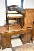 An early to mid 20th Century oak dressing table with similar unmatched bedside cabinet and stool