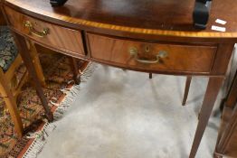 A nice quality reproduction bow fronted hall table having two frieze drawers on tapered legs with