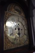 An 18th Century oak long cased clock having eight day movement and brass arched dial, named for