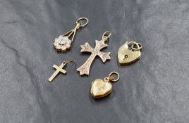 A 9ct gold heart padlock with attachment loop, along with 9ct gold and yellow metal pendants