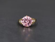 A 9ct gold pink gemstone and cubic zirconia ring, the large central round cut pink stone in a six