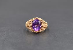 A 9ct gold amethyst ring, the central oval cut amethyst measuring approximately 2ct, in a six claw