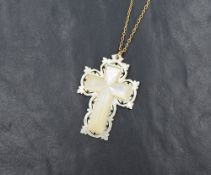 A decorative mother-of-pearl cross pendant, having a pierced border and 'Bethlehem' inscribed to the