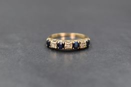 A 9ct gold sapphire and diamond half eternity band, the three illusion set diamond chips