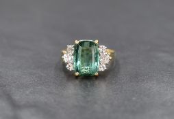 An 18ct gold green tourmaline and diamond ring, the tourmaline being approx 1.5ct in a 4 claw