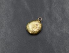 A gold nugget pendant, having two pendant loops marked 9ct with a horseshoe to the reverse, 2cm