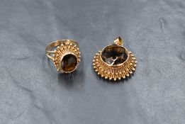 A high carat gold smoky quartz ring and pendant set, the oval cut smoky quartz in a bezel setting